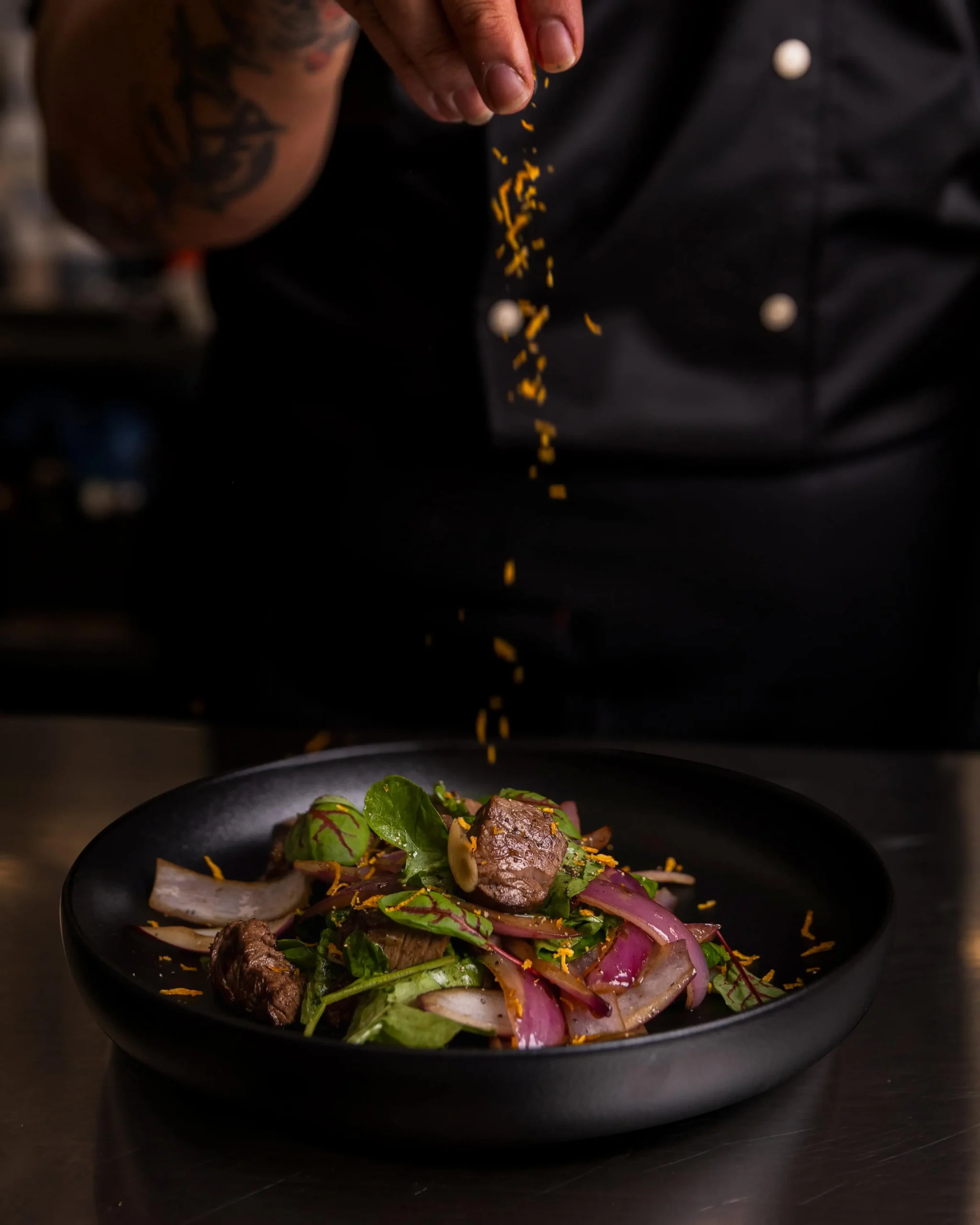 Chef preparing Pan-Asian cuisine at AKA Rooftop